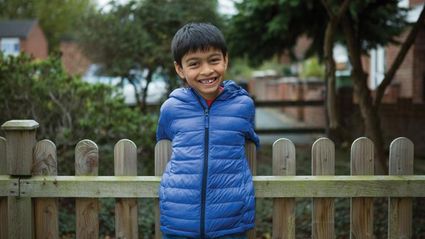 Boy leaning on the fence